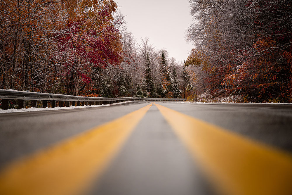Jason Mocniak photo of a road in light snow and autumn leaves