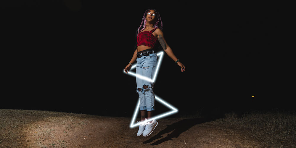 Meagan Bolds self-portrait at night with lighted triangles