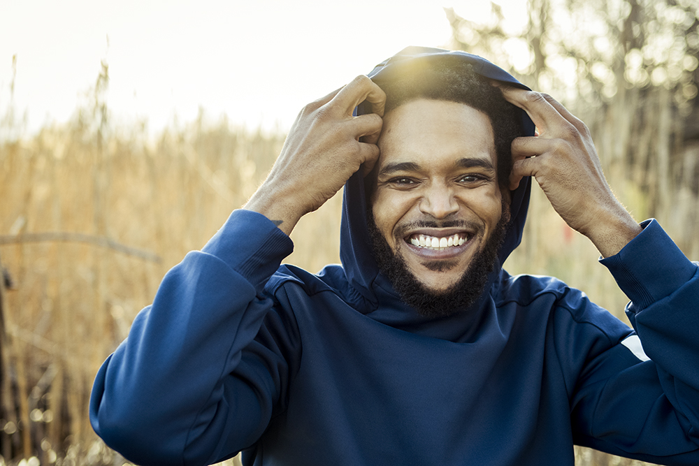 Gabriela Herman photo of a man in a blue hoodie in a marsh