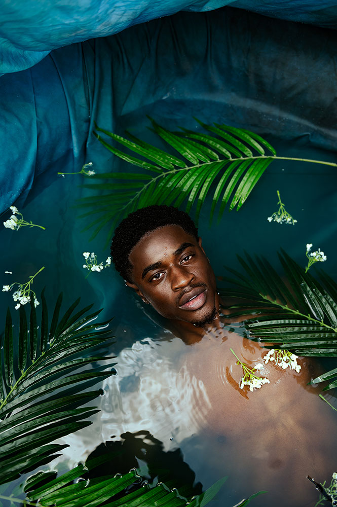 Inari Briana portrait of a young man in water with leaves