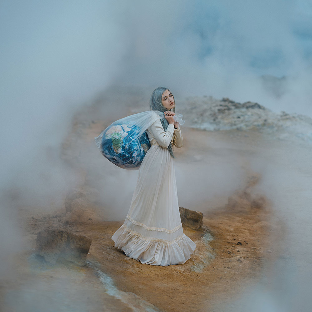 Anya Anti photo of a girl holding a globe in a plastic bag symbolizing greenhouse gases