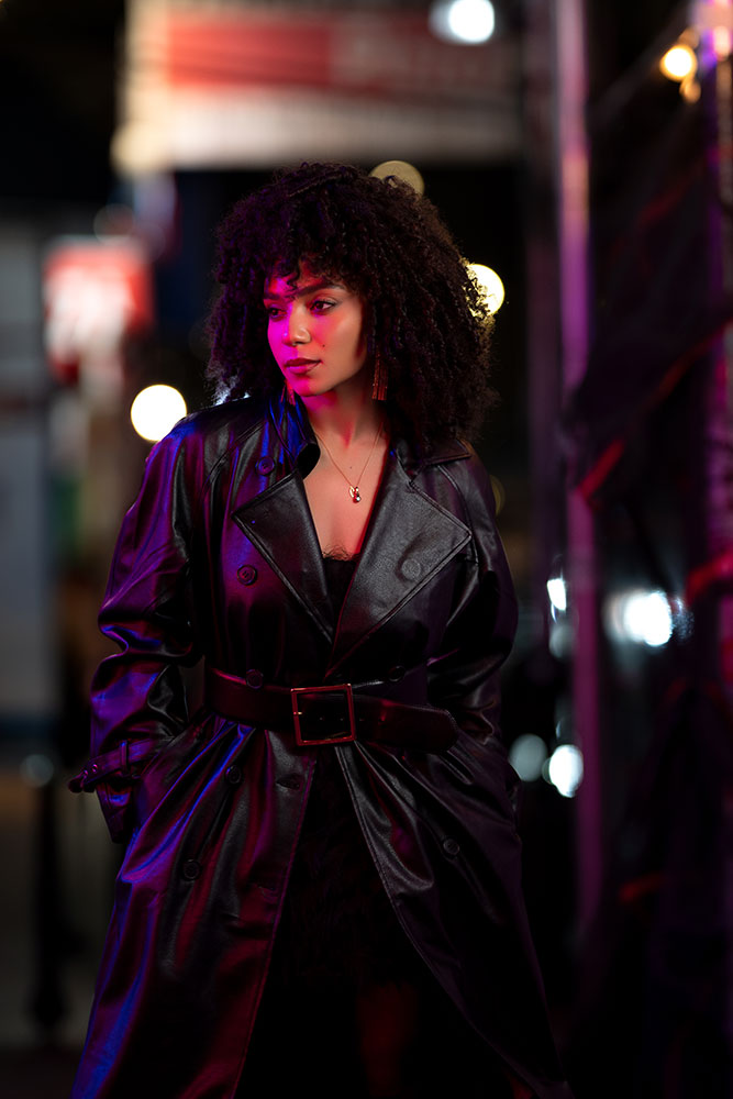 Aaron Pegg photo of a model at night, on the street, partly lit by pink neon