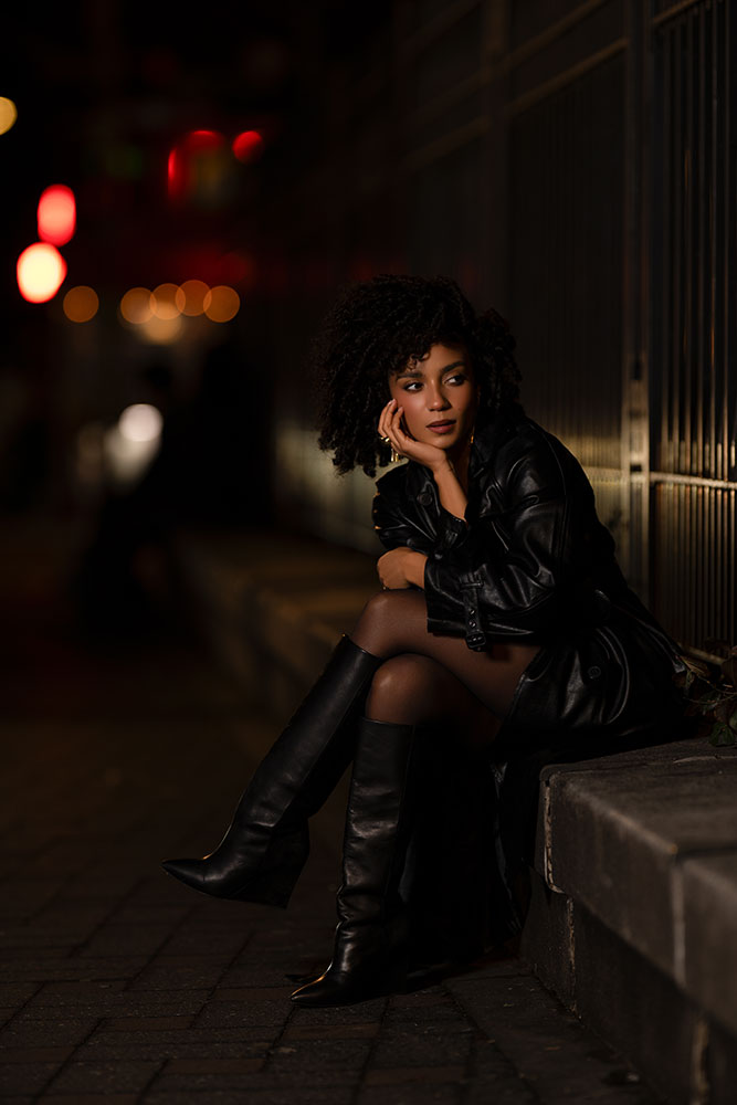 Aaron Pegg photo of a model at night, sitting on a bench, looking off camera