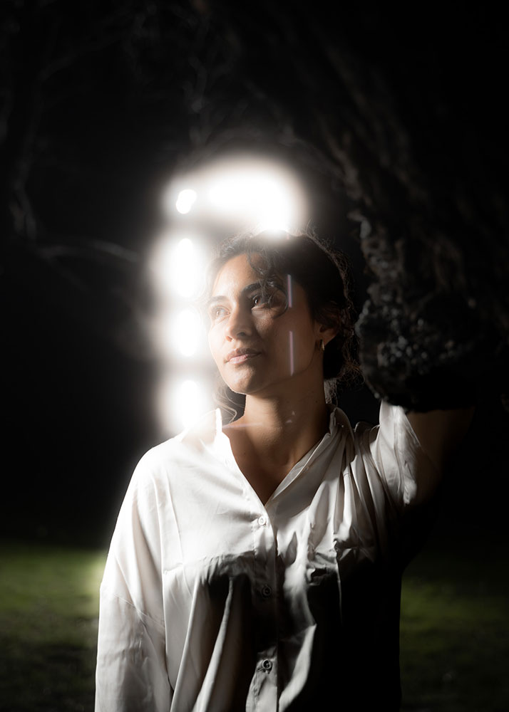 Arturo Carillo photo of a woman at night illuminated partially by white light behind her