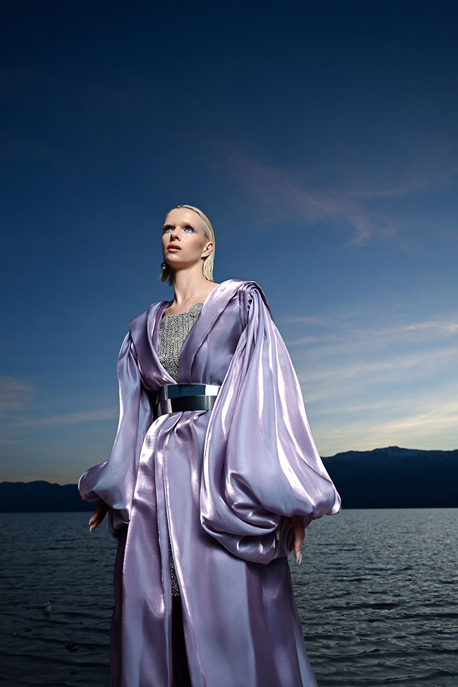 Joyce Charat photo of a model standing in front of a lake, wearing a flowy purple outfit, taken with the Z6III