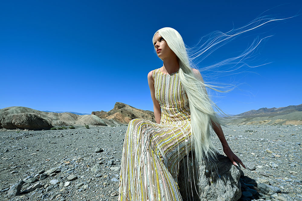 Joyce Charat photo of a model sitting on a rock in the desert, with hair flowing, taken with the Z6III