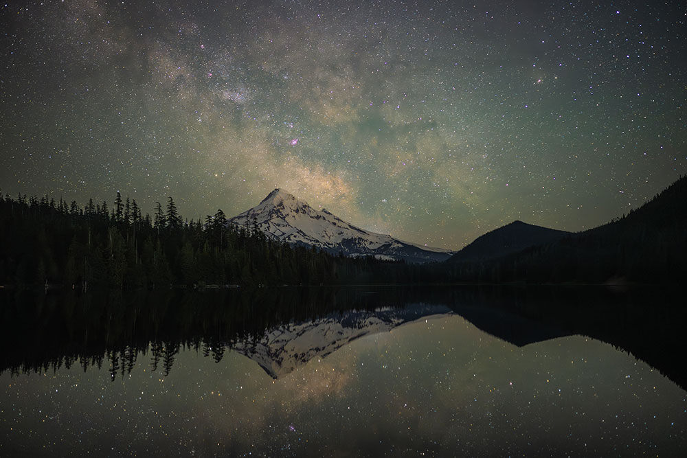 Julia Icenogle photo of a starry sky over a mountain landscape and its reflection in a lake