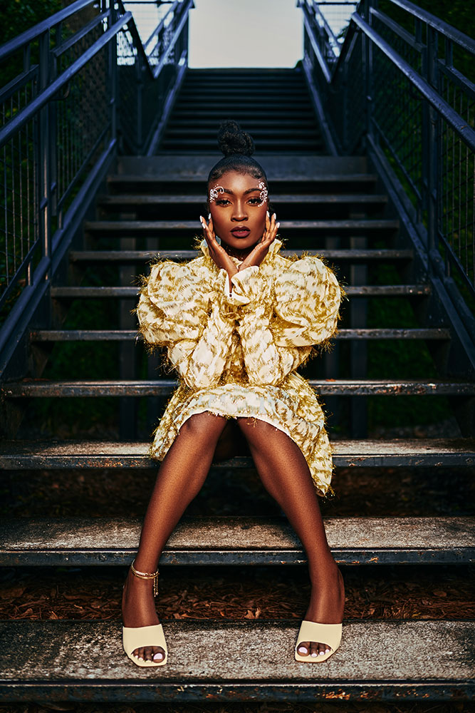 Troy with the camera (Troy Sawyer) portrait of a model in yellow, sitting on a set of stairs outdoors