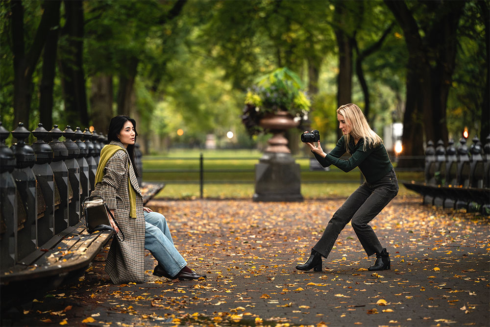Brittany Kunkel photographing a model in the park with the Z50II mirrorless camera