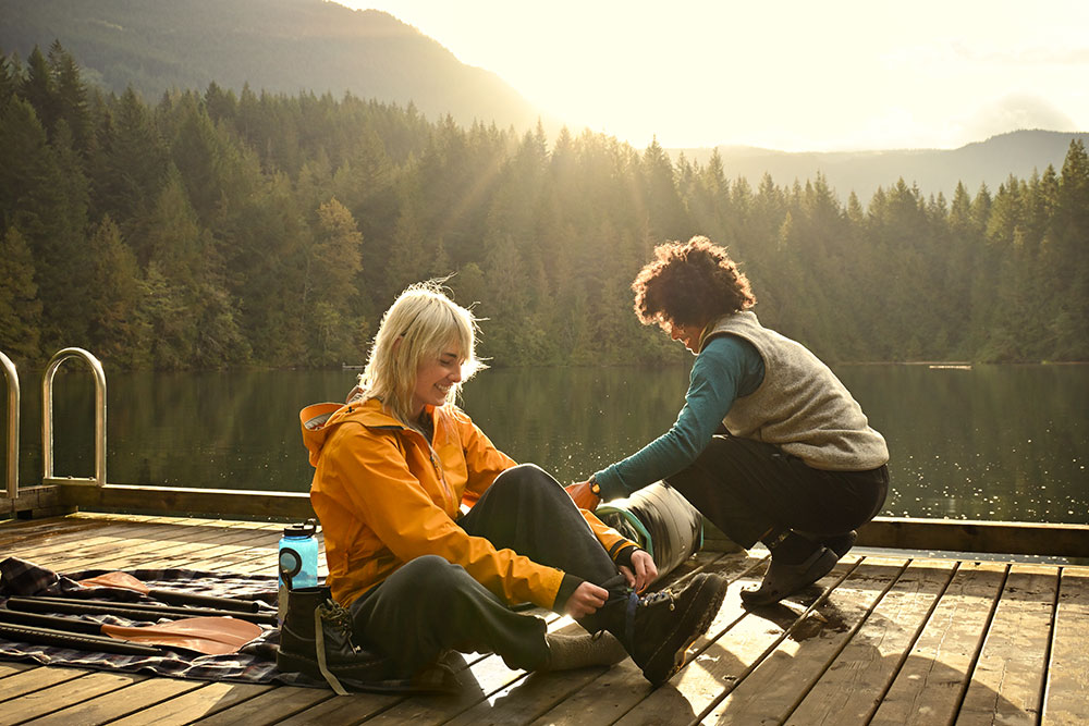 Ian Harland on a dock with a model at sunrise